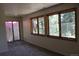 Cozy bedroom with carpet, two windows providing natural light, and a door leading to a deck at 28650 Cavan Ln, Evergreen, CO 80439