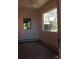 Bright room with two windows, wood floors, and baseboard heating, awaiting personal touches at 28650 Cavan Ln, Evergreen, CO 80439
