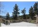 This beautiful deck provides an amazing view of tall trees, mountains and clear blue skies at 28650 Cavan Ln, Evergreen, CO 80439