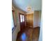 Inviting entryway with a wooden door, hardwood floors, closet, and decorative light fixture at 28650 Cavan Ln, Evergreen, CO 80439