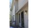 Exterior door with a wood deck and railings, paired with stylish outdoor lighting at 28650 Cavan Ln, Evergreen, CO 80439