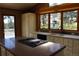 Kitchen with center island cooktop, white cabinets, and a view of the deck at 28650 Cavan Ln, Evergreen, CO 80439