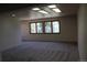 Bright living room with neutral carpet, recessed lighting, and two windows to view the outdoors at 28650 Cavan Ln, Evergreen, CO 80439