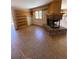Bright living room with brick fireplace, tile flooring and built-in bookshelf at 28650 Cavan Ln, Evergreen, CO 80439