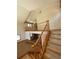 View of staircase with wood railing and banister leading to a second-floor landing at 28650 Cavan Ln, Evergreen, CO 80439