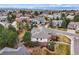 Aerial view of a beautiful two-story home with manicured lawn and mature trees in a quiet neighborhood at 9188 Buck Hill Dr, Highlands Ranch, CO 80126