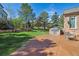 Expansive backyard features a built-in grill, stamped concrete patio, and mature trees, perfect for entertaining at 9188 Buck Hill Dr, Highlands Ranch, CO 80126