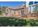 Beautiful backyard patio features an outdoor kitchen, dining area, and lush lawn for Gathering gatherings at 9188 Buck Hill Dr, Highlands Ranch, CO 80126