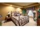 Cozy bedroom with a decorative iron bed, layered bedding and warm light makes for a relaxing setting at 9188 Buck Hill Dr, Highlands Ranch, CO 80126