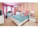 Bright bedroom with cheerful pink and yellow color scheme, offering a cozy and inviting space at 9188 Buck Hill Dr, Highlands Ranch, CO 80126