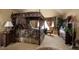 Main bedroom featuring a canopy bed, decorative curtains, and custom furnishings at 9188 Buck Hill Dr, Highlands Ranch, CO 80126