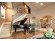 A home foyer featuring stairs, a grand piano, and access to the formal dining room at 9188 Buck Hill Dr, Highlands Ranch, CO 80126