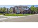 Street view of an elegant brick home with manicured lawn and a three car garage at 9188 Buck Hill Dr, Highlands Ranch, CO 80126