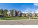 Traditional brick home with a well-maintained lawn and mature trees at 9188 Buck Hill Dr, Highlands Ranch, CO 80126