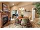 A living room with a fireplace and an adjacent dining room at 9188 Buck Hill Dr, Highlands Ranch, CO 80126