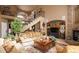 Spacious living room with a fireplace, staircase, and comfortable seating arrangements at 9188 Buck Hill Dr, Highlands Ranch, CO 80126