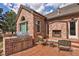 Brick patio with built-in grill and outdoor fireplace, perfect for year-round entertainment and cooking at 9188 Buck Hill Dr, Highlands Ranch, CO 80126