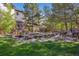 Picturesque backyard pond with a small wooden bridge, rock features, and bronze deer sculptures at 9188 Buck Hill Dr, Highlands Ranch, CO 80126
