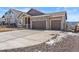 Beautiful home featuring a three car garage, stone accents, and a well kept lawn at 16838 Greyhawk Dr, Monument, CO 80132