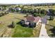 Aerial view of a home with well-kept landscaping, a gazebo and views beyond at 42340 Kingsmill Cir, Elizabeth, CO 80107