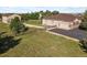 Expansive lot with mature trees, lush lawn, wood fence, and a long asphalt driveway that leads to the home at 42340 Kingsmill Cir, Elizabeth, CO 80107
