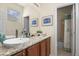 Bright bathroom with granite counters, modern faucet and view of tub shower combo at 42340 Kingsmill Cir, Elizabeth, CO 80107