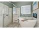 Modern bathroom showcasing a freestanding tub, glass shower, and tiled walls for a clean and sleek design at 42340 Kingsmill Cir, Elizabeth, CO 80107