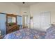 Bright bedroom features blue accent, vintage dresser, and doorway to hall with closet at 42340 Kingsmill Cir, Elizabeth, CO 80107