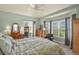 Bright bedroom features large windows, dresser, leather chair, and access to outdoor patio at 42340 Kingsmill Cir, Elizabeth, CO 80107