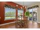 Bright dining area featuring a round table, four chairs, and a large window overlooking the backyard at 42340 Kingsmill Cir, Elizabeth, CO 80107