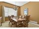 Formal dining room with a large table, chandelier, and a large window with natural light at 42340 Kingsmill Cir, Elizabeth, CO 80107