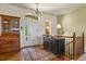 Bright foyer with hardwood floors, a beautiful rug, and staircase visible upon entry at 42340 Kingsmill Cir, Elizabeth, CO 80107