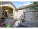 Inviting front entrance with covered porch, seating, and colorful flower arrangements near a two car garage at 42340 Kingsmill Cir, Elizabeth, CO 80107