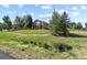 Charming single-story home featuring stone accents and a well-manicured front yard at 42340 Kingsmill Cir, Elizabeth, CO 80107