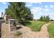 Beautifully landscaped front yard with stone mailbox, mature trees, and a well-maintained lawn at 42340 Kingsmill Cir, Elizabeth, CO 80107