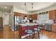 Modern kitchen with stainless steel appliances, central island with seating, and hardwood floors at 42340 Kingsmill Cir, Elizabeth, CO 80107