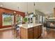 Spacious kitchen featuring wood cabinets, hardwood floors, an island and a dining area at 42340 Kingsmill Cir, Elizabeth, CO 80107
