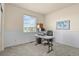 Home office with wainscotting features a window, a functional desk, and a comfortable chair at 42340 Kingsmill Cir, Elizabeth, CO 80107