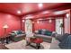 Red basement offering cozy seating, bright lighting, and a staircase in the background at 2032 W Nantucket Ct, Littleton, CO 80120