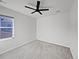 Bright bedroom with neutral carpet, walls, and a window for plenty of natural light at 10689 Uravan St, Commerce City, CO 80022