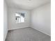 A bright bedroom features neutral carpet, white walls, and a window for natural light at 10689 Uravan St, Commerce City, CO 80022