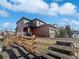 Rear exterior view of a two-story home with a fenced backyard at 10689 Uravan St, Commerce City, CO 80022