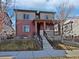 Charming two-story home with well-maintained landscaping and inviting front porch at 10689 Uravan St, Commerce City, CO 80022