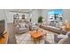 Bright living room featuring modern furnishings and view into the kitchen at 10689 Uravan St, Commerce City, CO 80022