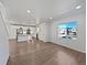 Open-concept living room with wood floors and bright natural light at 10689 Uravan St, Commerce City, CO 80022