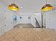Open living space with modern lighting, neutral walls and staircase to the upper level at 10689 Uravan St, Commerce City, CO 80022