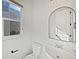 Clean powder room boasts a modern vanity with a stylish sink and a window at 10689 Uravan St, Commerce City, CO 80022