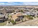 Aerial view of a home featuring a landscaped yard and neighborhood with mountain views at 223 Castlemaine Ct, Castle Rock, CO 80104
