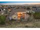 Home exterior showcasing a landscaped yard with stone patio, fire pit, hot tub and mountain views at 223 Castlemaine Ct, Castle Rock, CO 80104