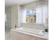 Relaxing bathroom features a soaking tub with marble surround and separate glass shower at 223 Castlemaine Ct, Castle Rock, CO 80104